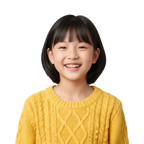 A young girl with a bob haircut smiles brightly, wearing a textured yellow sweater, against a plain white background, conveying joy and warmth.
