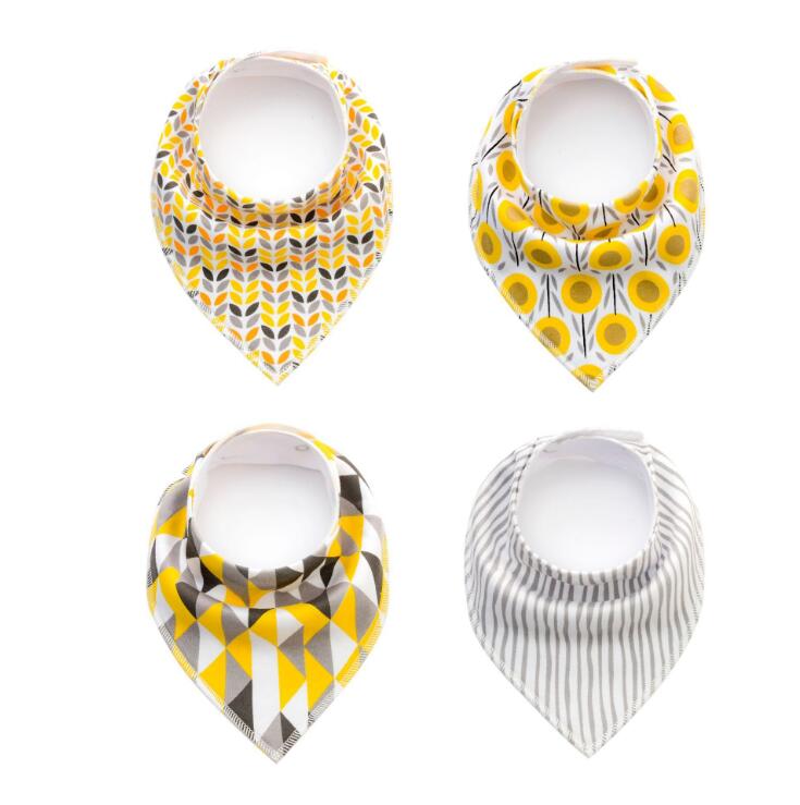 Set of four Nova Mart baby bibs and burp cloths with arrow, wave, and triangle prints, made of soft cotton bandana fabric.