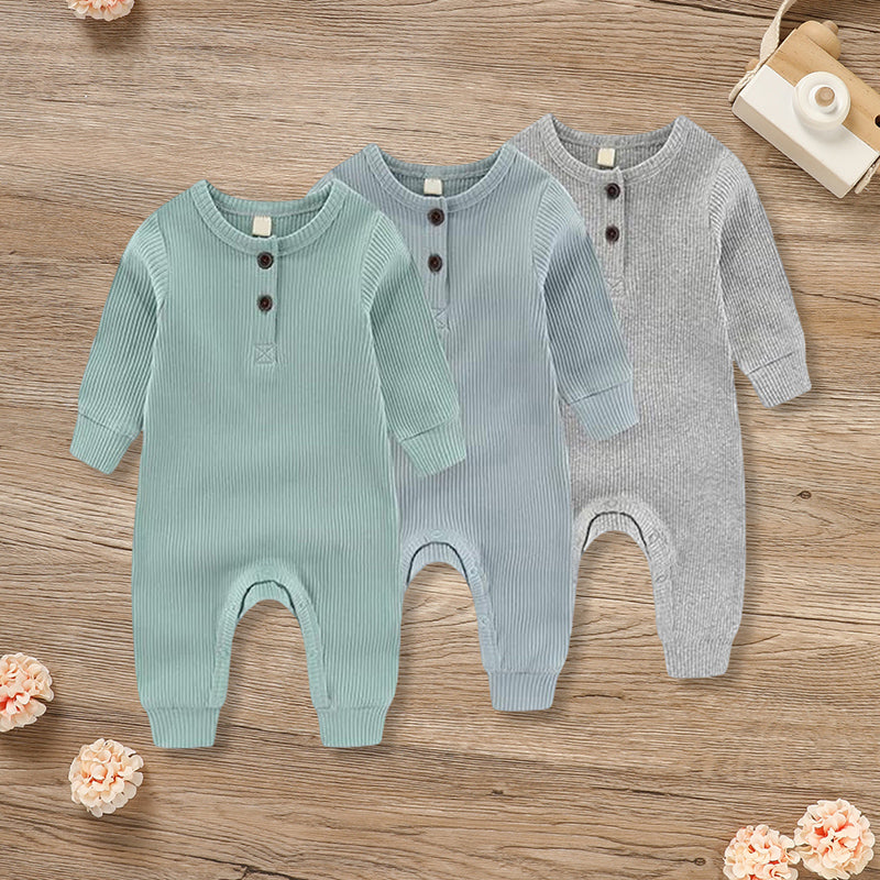 Three newborn baby boys and girls in soft, long sleeve ribbed romper jumpsuits with button fronts, by Nova Mart.