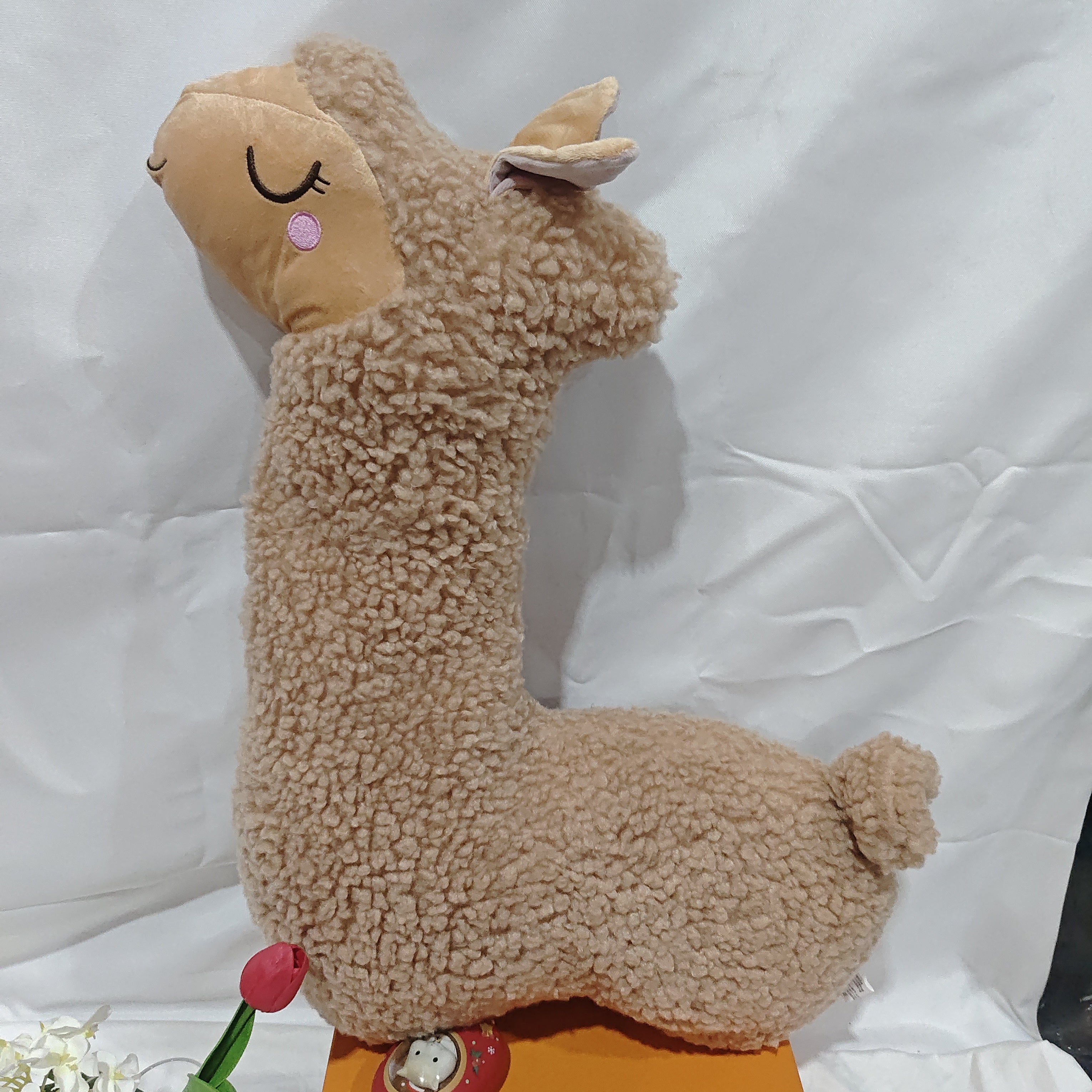 Soft alpaca plush toy pillow by Nova Mart featuring a cuddly, realistic alpaca design perfect for comfort and decorative use.
