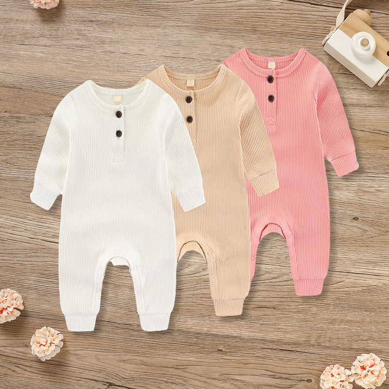 Three newborn baby boys and girls in soft, ribbed long sleeve jumpsuits with button-front closures by Nova Mart.