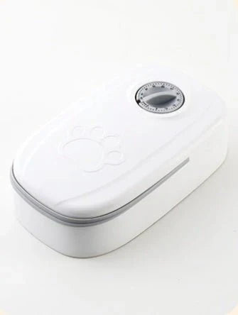 Automatic pet feeder with a silver button on a white background