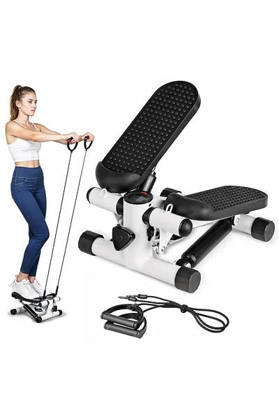 Woman using a black and white exercise stepper with resistance bands on a white background