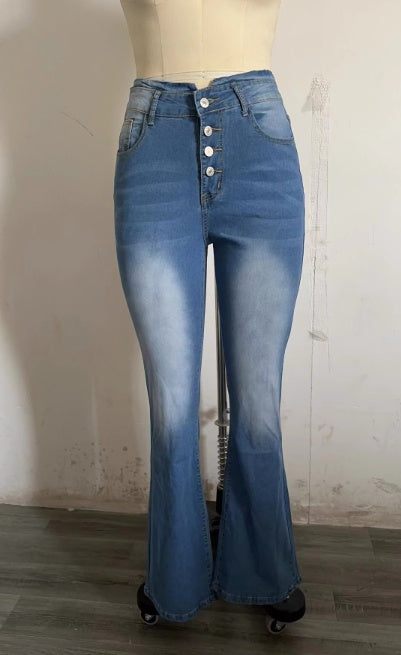 Blue flared jeans on a mannequin against a plain wall.