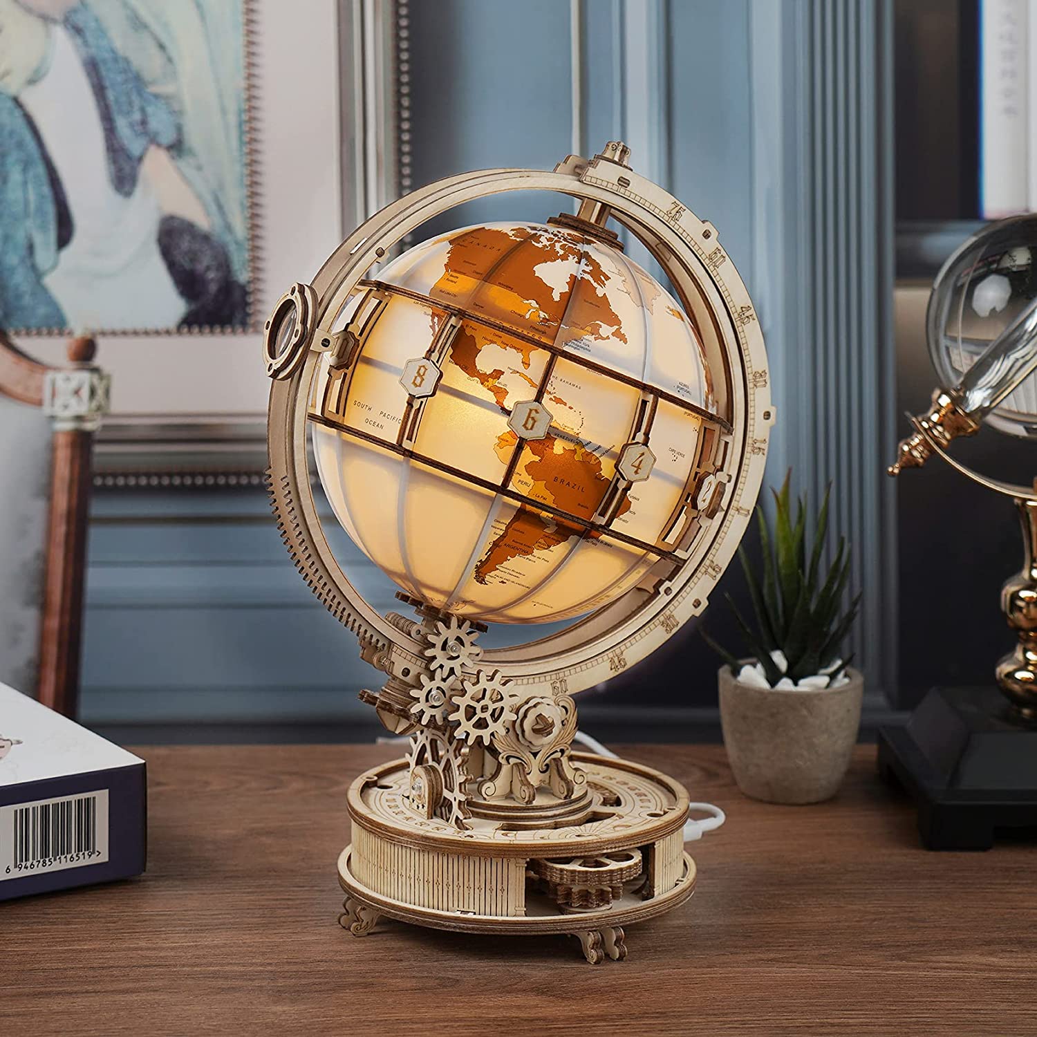 Decorative globe with gears on a wooden surface in a room setting