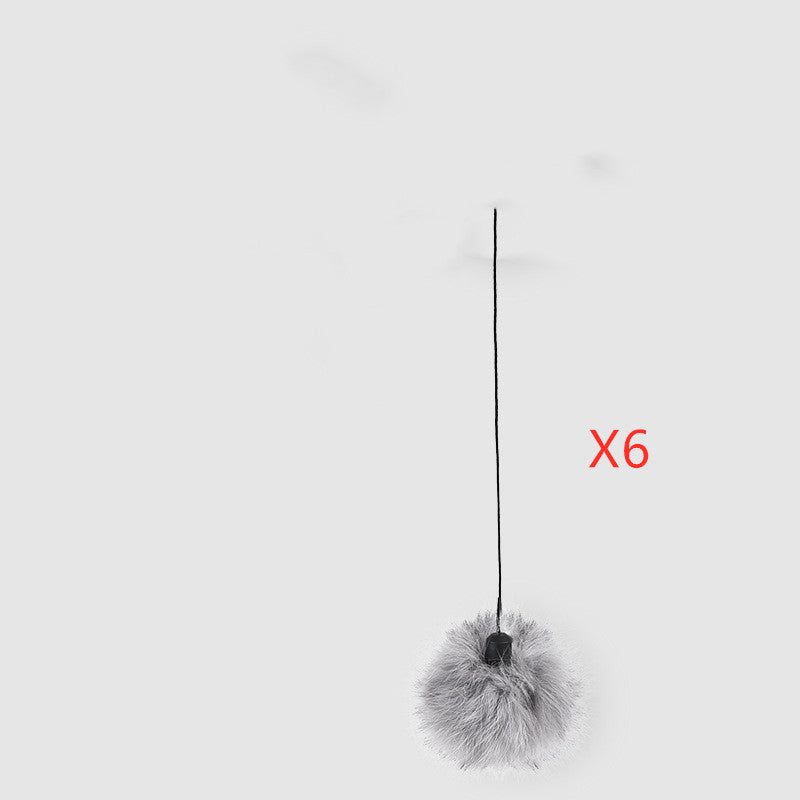 Cat toy with a fluffy ball and string on a white background