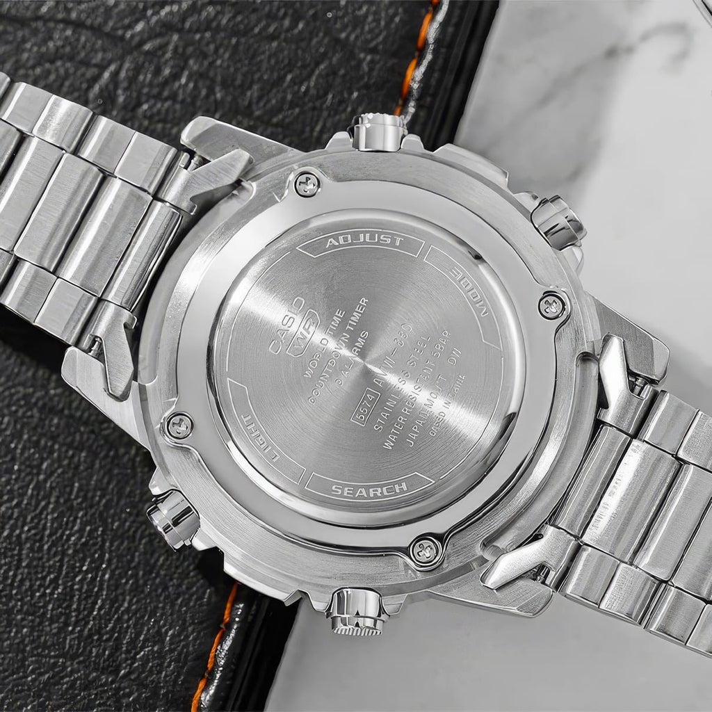 Close-up of a silver Casio watch with metallic band on a textured surface