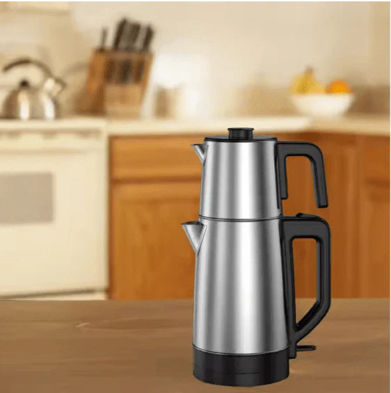 Stainless steel coffee percolator on a kitchen counter with blurred background