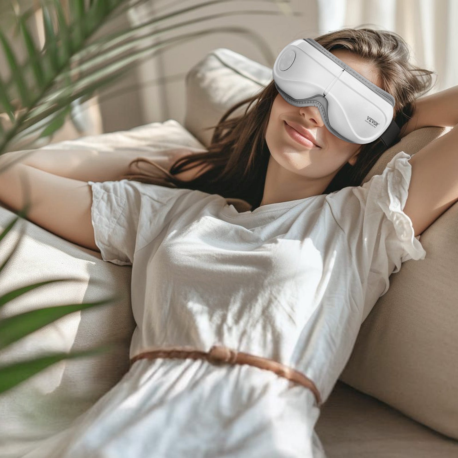 Woman wearing a sleep mask on a couch with plants around