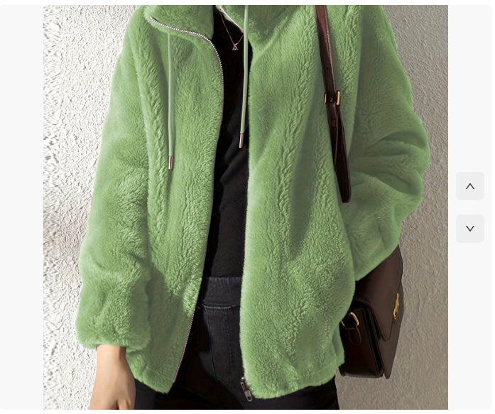 Green fleece jacket worn by a person against a neutral background