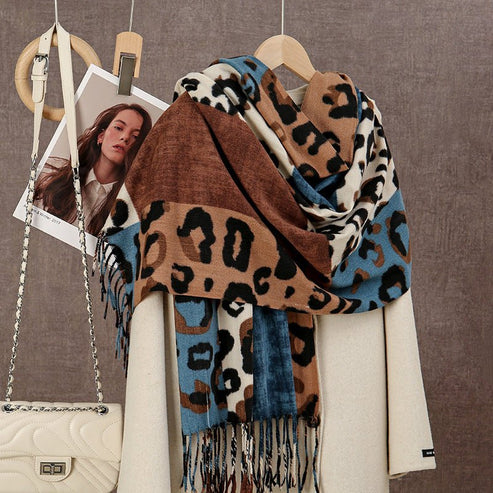 Leopard print scarf draped over a coat with a handbag on a hanger against a brown background