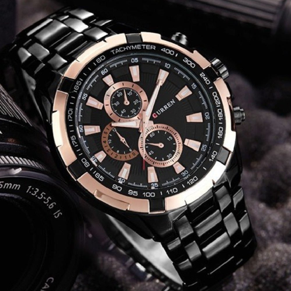 Luxury watch with black and rose gold design on a dark background