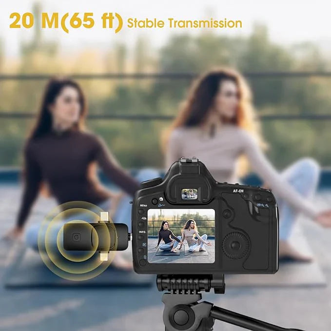 Camera with a microphone attached, showing a view of two people sitting on the ground.