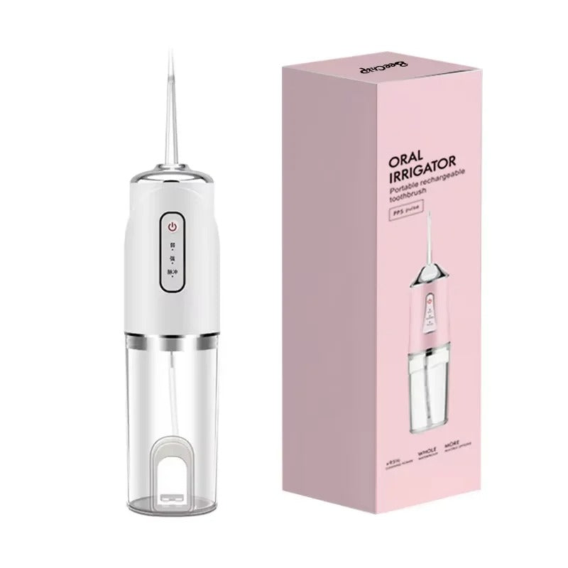 White oral irrigator with pink packaging on a white background