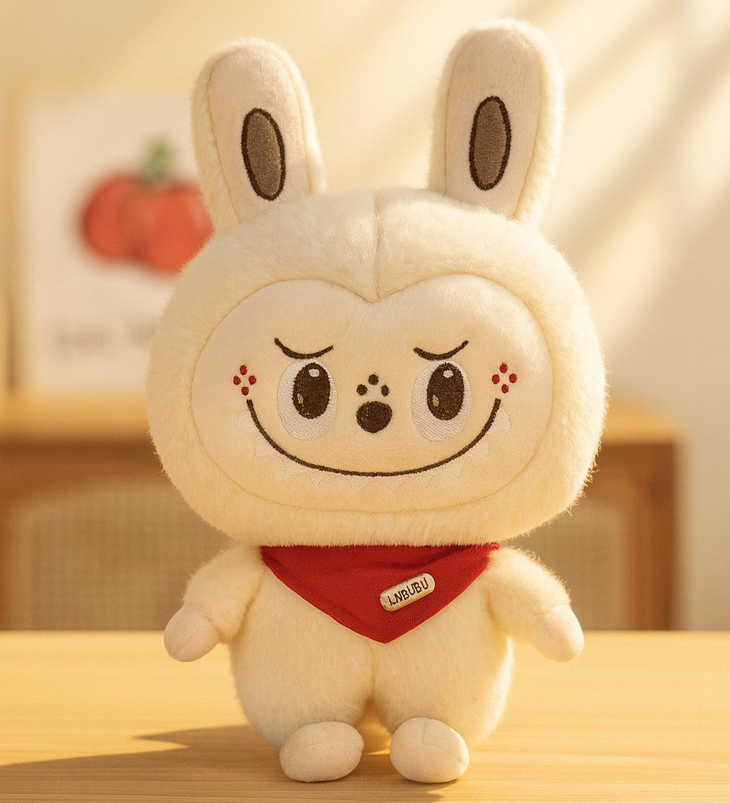 Plush toy with a cute face and red scarf on a wooden surface