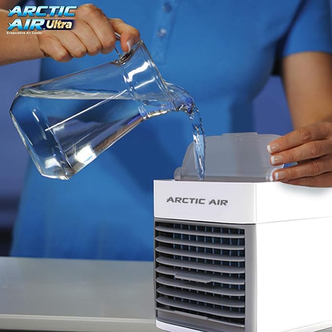 Person pouring water into an Arctic Air humidifier with a blue background