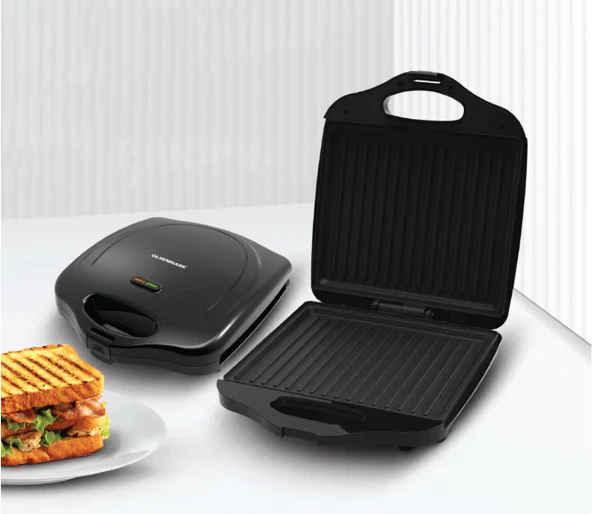Black sandwich press with grill surface on a white background