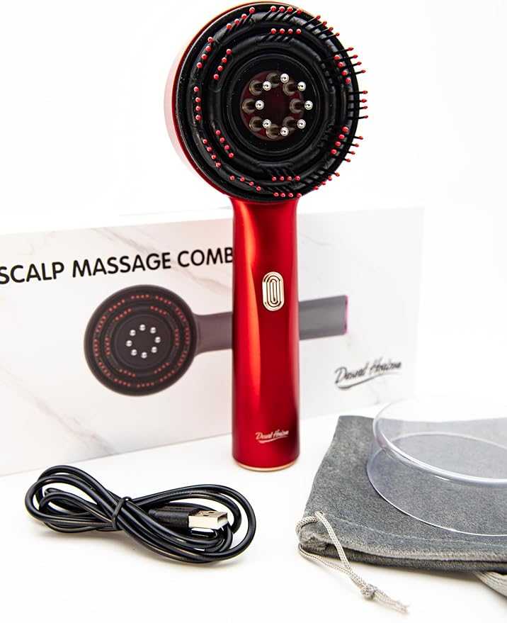 Red scalp massage comb with black bristles on a white background