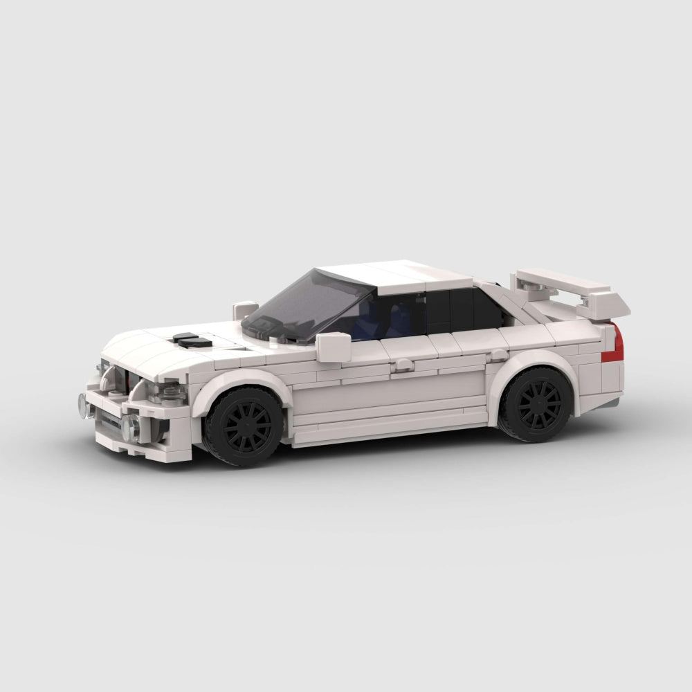 White toy car model made of interlocking bricks on a light gray background