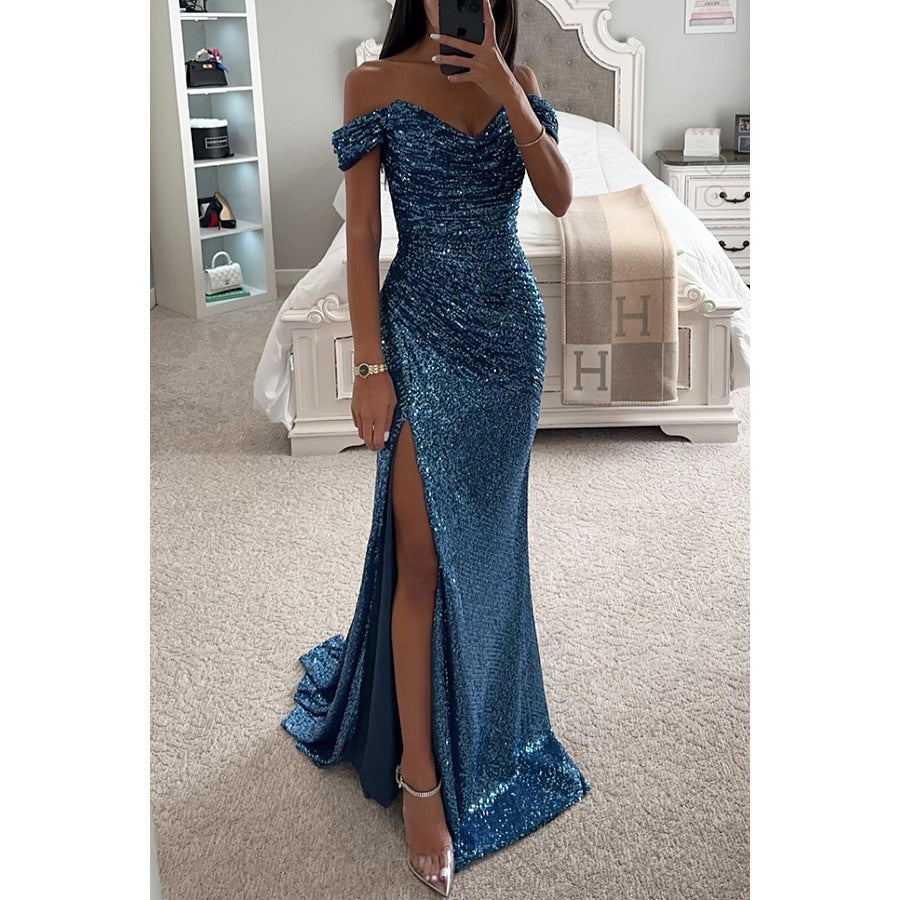 Woman wearing a blue sequin dress with a slit in a bedroom setting