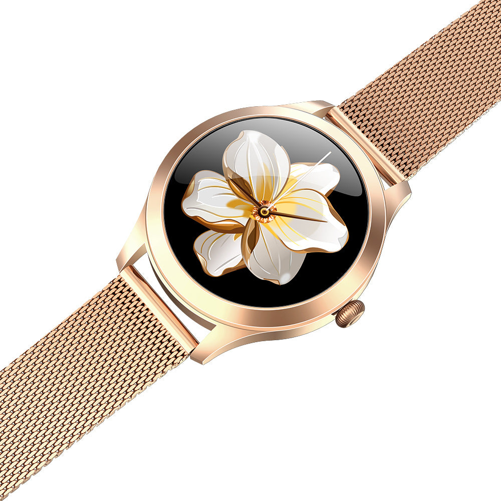 Rose gold watch with floral design on the face against a white background