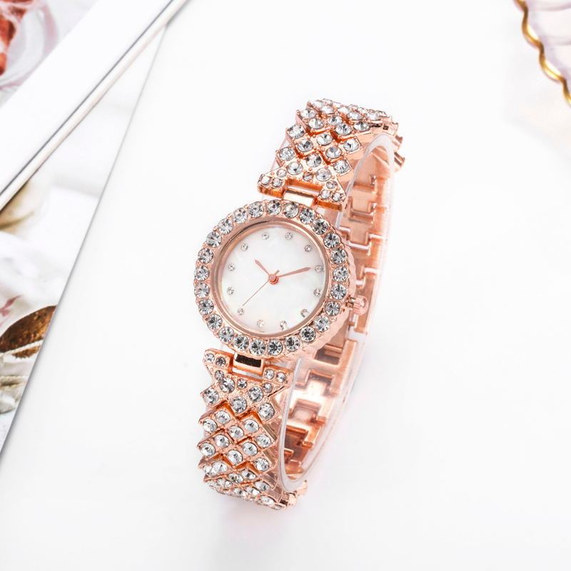 Rose gold watch with diamond accents on a white background